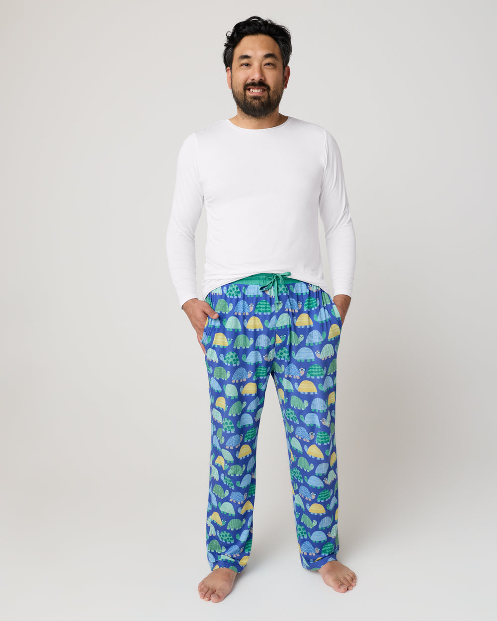 Man wearing the Shell Parade Men's Pajama Pants with a white top