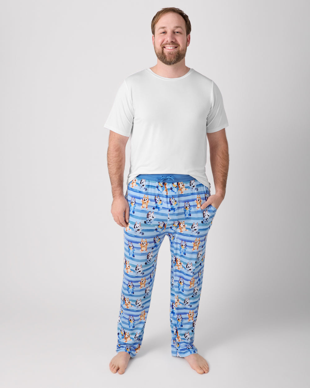 Man wearing the Bluey Dance All Day Men's Pajama Pants with a white top