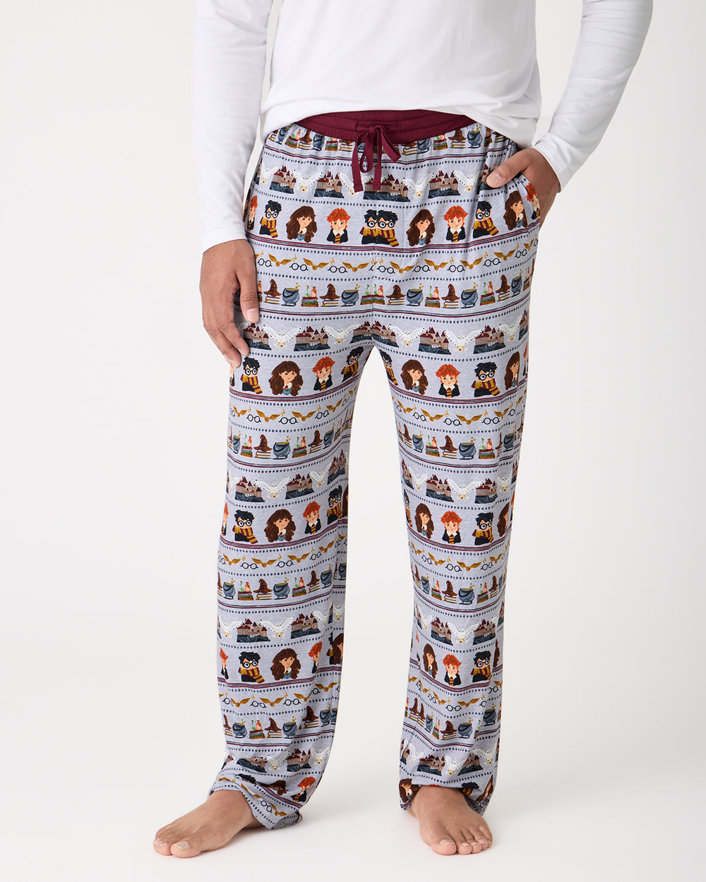 Man wearing the Harry Potter™ Spellbinding Studies Men's Pajama Pants with a white top