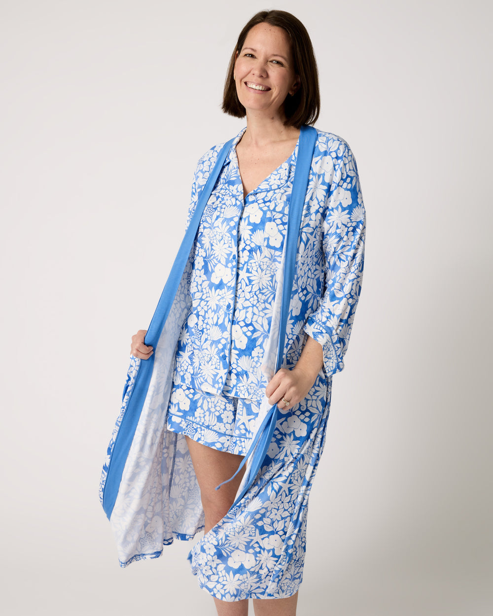 Woman wearing the Azure Garden Women's Robe over a matching PJ set