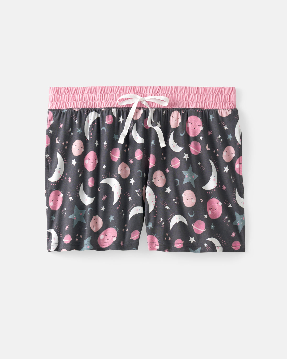 A pair of women's sleep shorts featuring a dark gray background with a playful pattern of pink planets, white crescent moons, and stars. The shorts have a bright pink elastic waistband and a white drawstring.