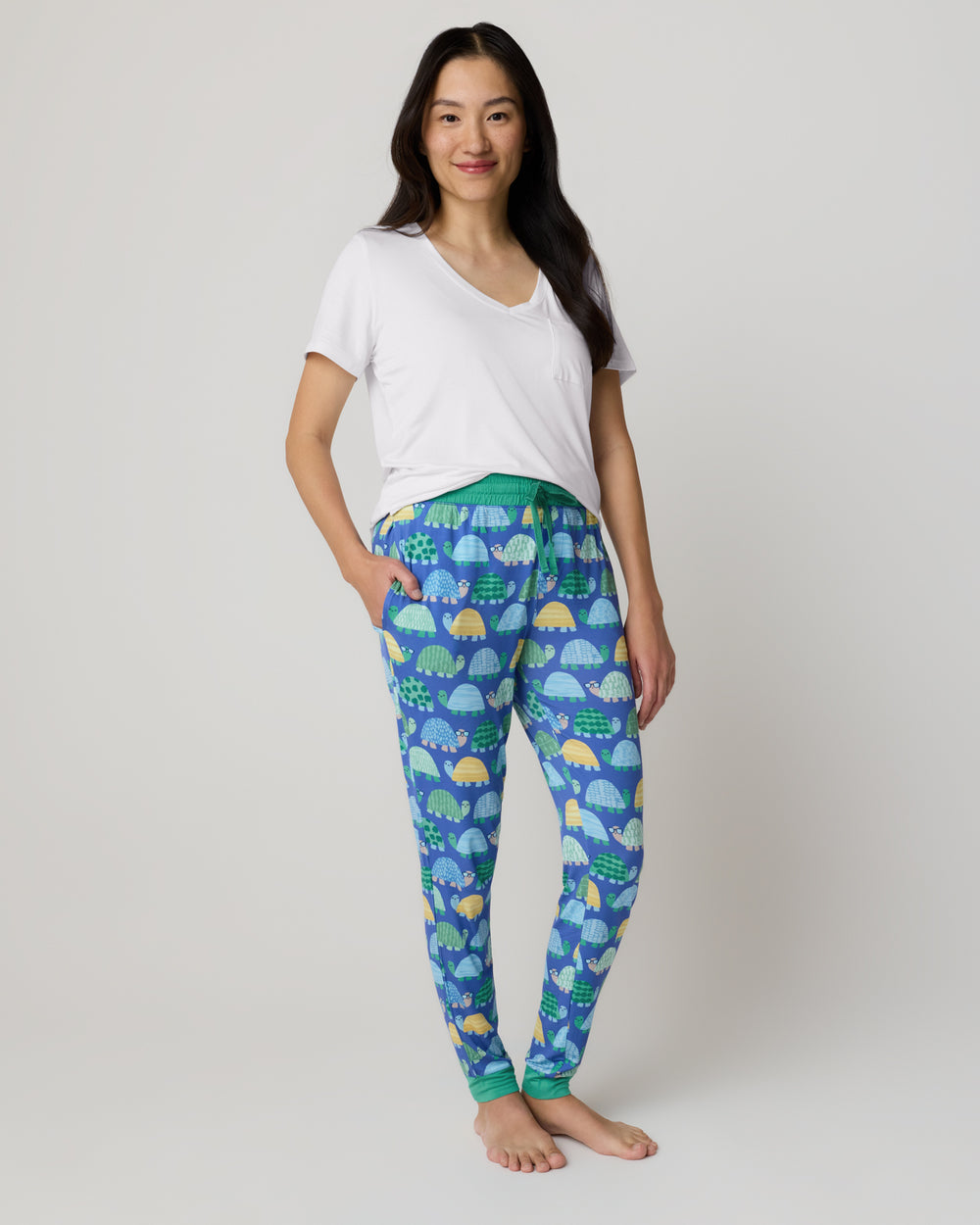 Woman wearing the Shell Parade Women's Pajama Pants with a white short sleeve top