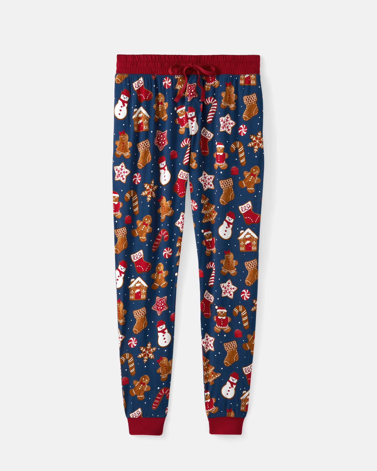 A pair of navy blue holiday-themed jogger pants with a red elastic waistband, red drawstring, and red ribbed ankle cuffs. The pants feature an all-over festive print of gingerbread houses, candy canes, snowmen, stockings, and stars.