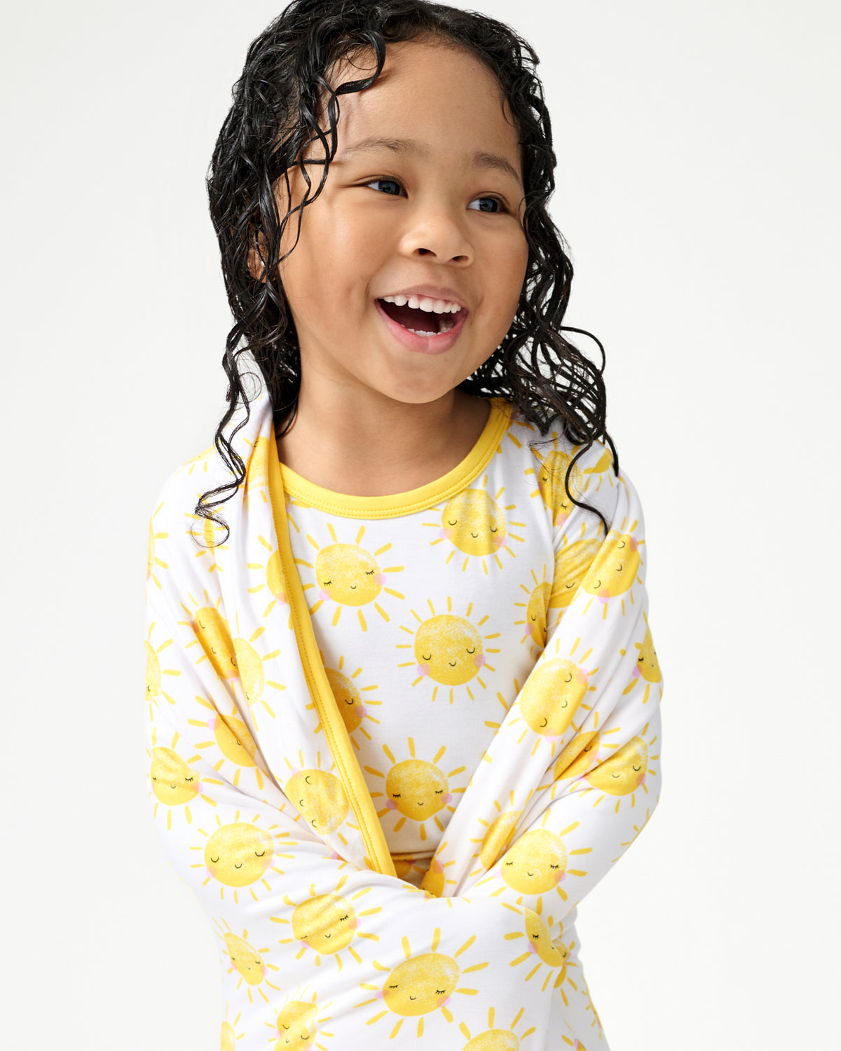 Close up of girl wrapped in the Sunshine Large Cloud Blanket®