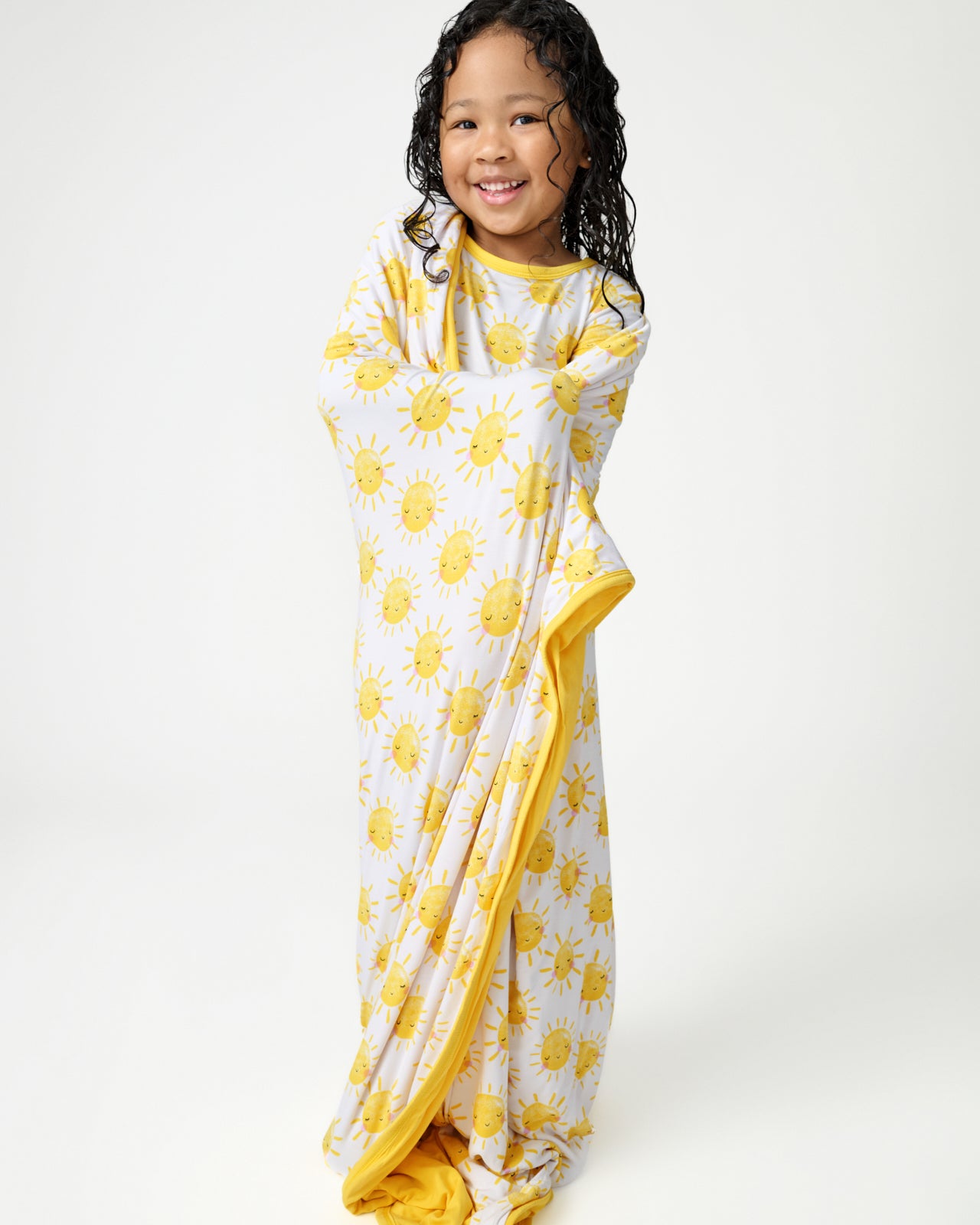 Standing girl wrapped in the Sunshine Large Cloud Blanket®