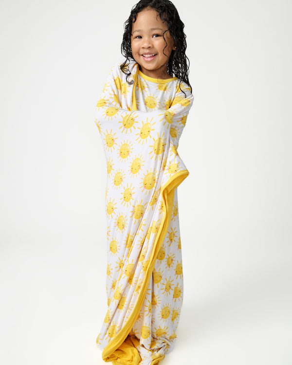 Standing girl wrapped in the Sunshine Large Cloud Blanket®