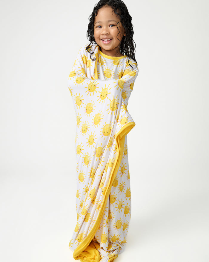 Standing girl wrapped in the Sunshine Large Cloud Blanket®