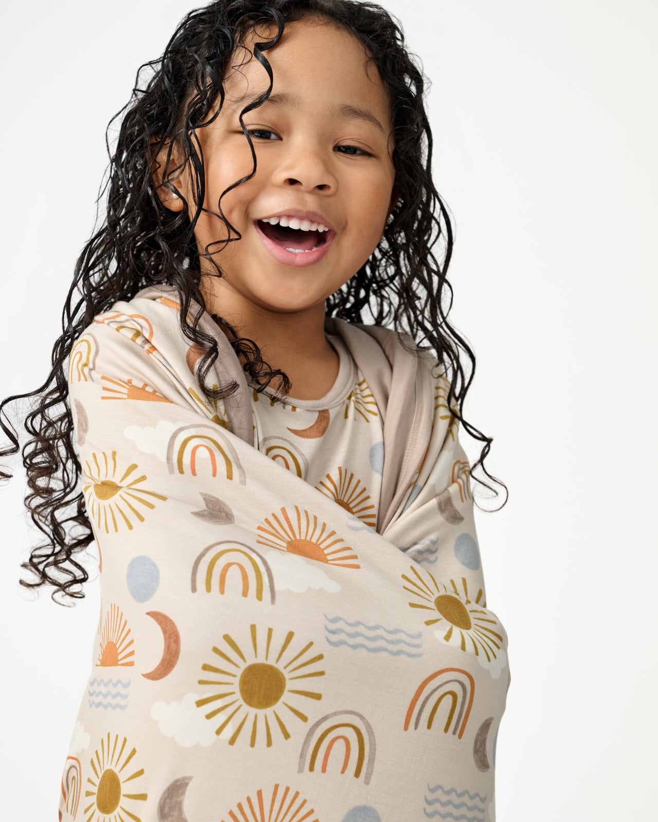 Close up of girl wrapped in the Desert Sunrise Large Cloud Blanket®