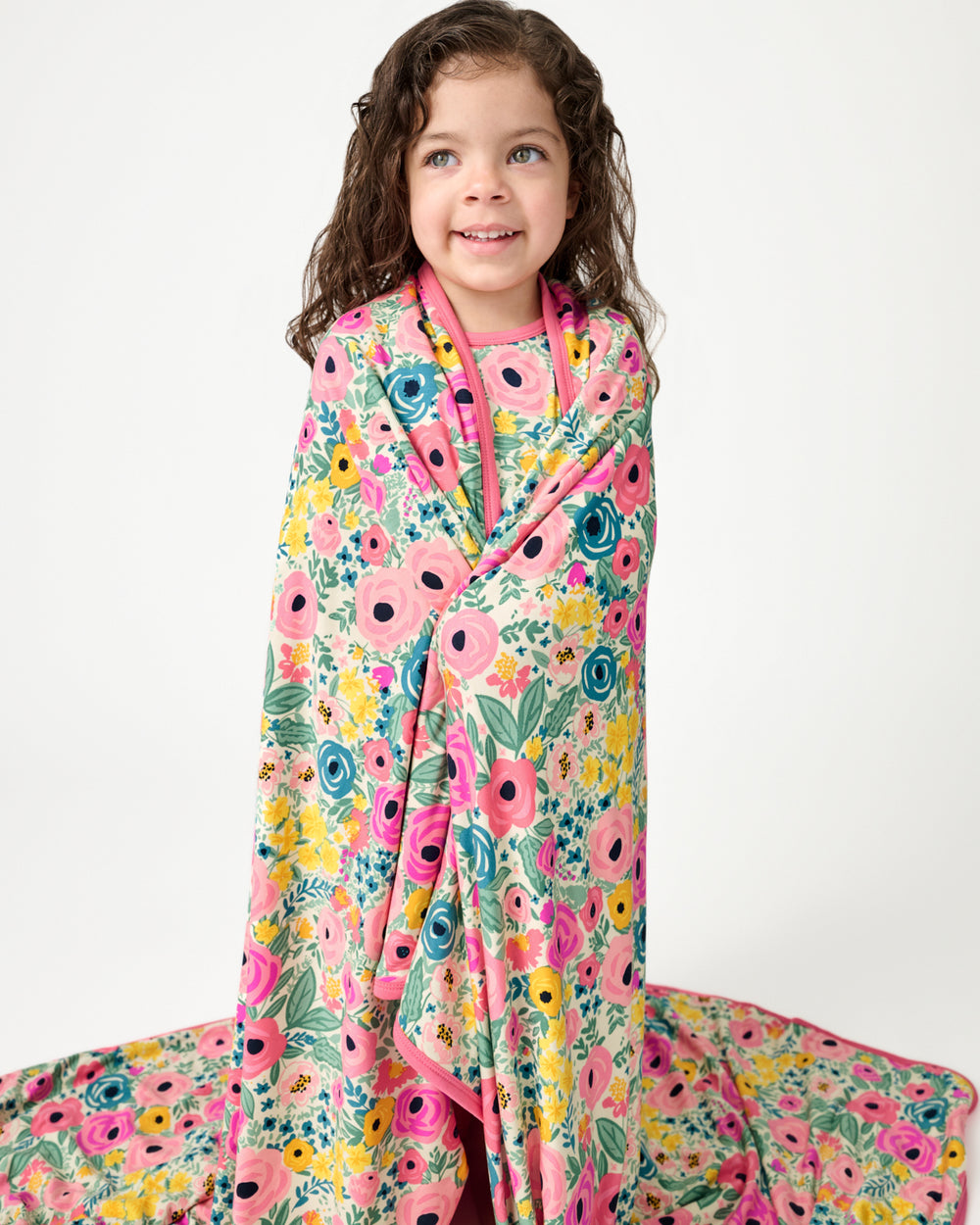 Standing girl wrapped in the Secret Garden Large Cloud Blanket®
