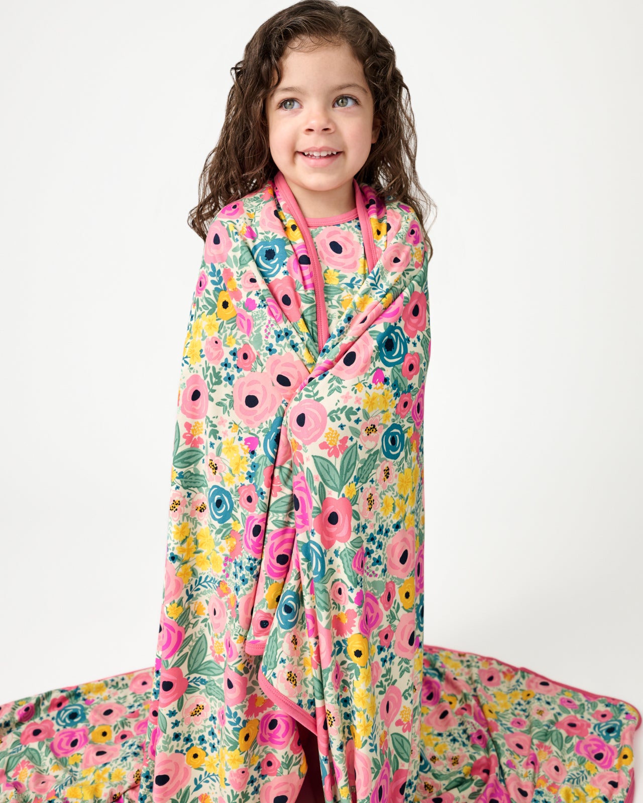 Standing girl wrapped in the Secret Garden Large Cloud Blanket®