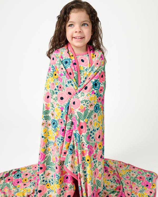Standing girl wrapped in the Secret Garden Large Cloud Blanket®