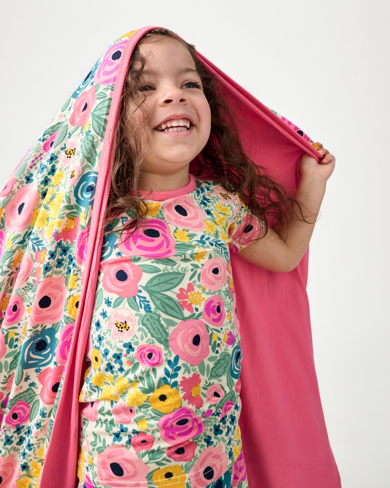 Close up of girl with the Secret Garden Large Cloud Blanket® draped over her head