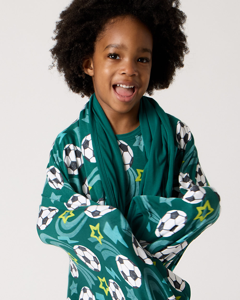Close up of child wrapped in the Soccer Stars Large Cloud Blanket®