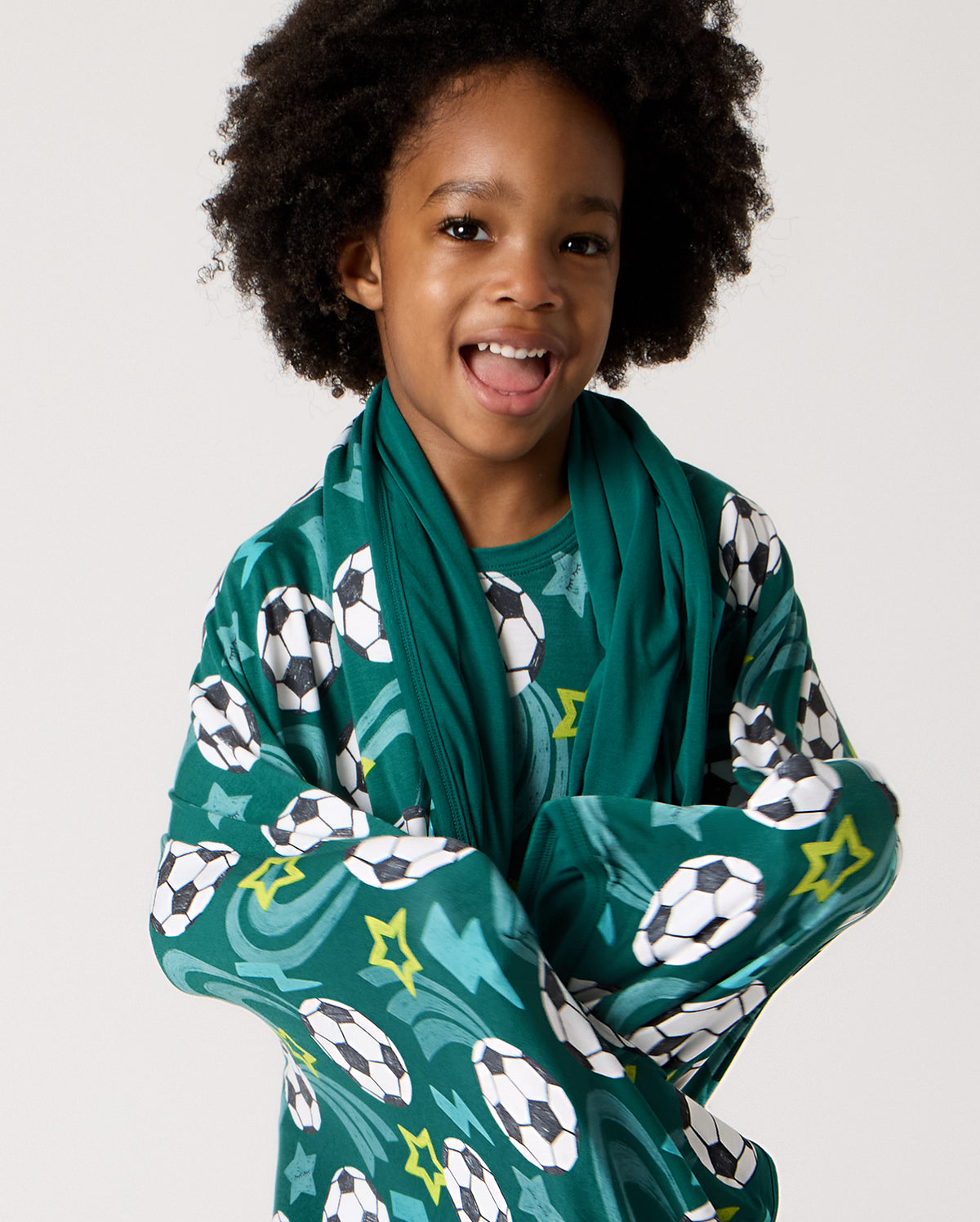 Close up of child wrapped in the Soccer Stars Large Cloud Blanket®