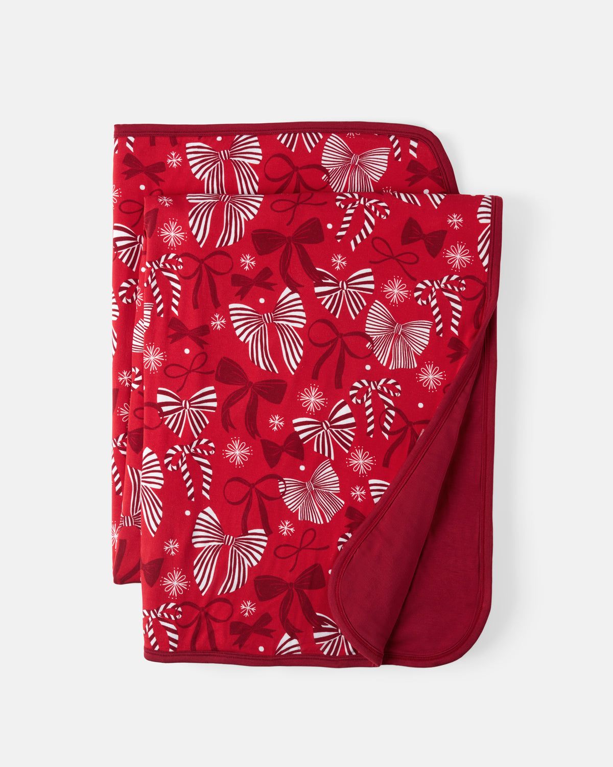 Flat lay of the Holiday Bows Large Cloud Blanket®