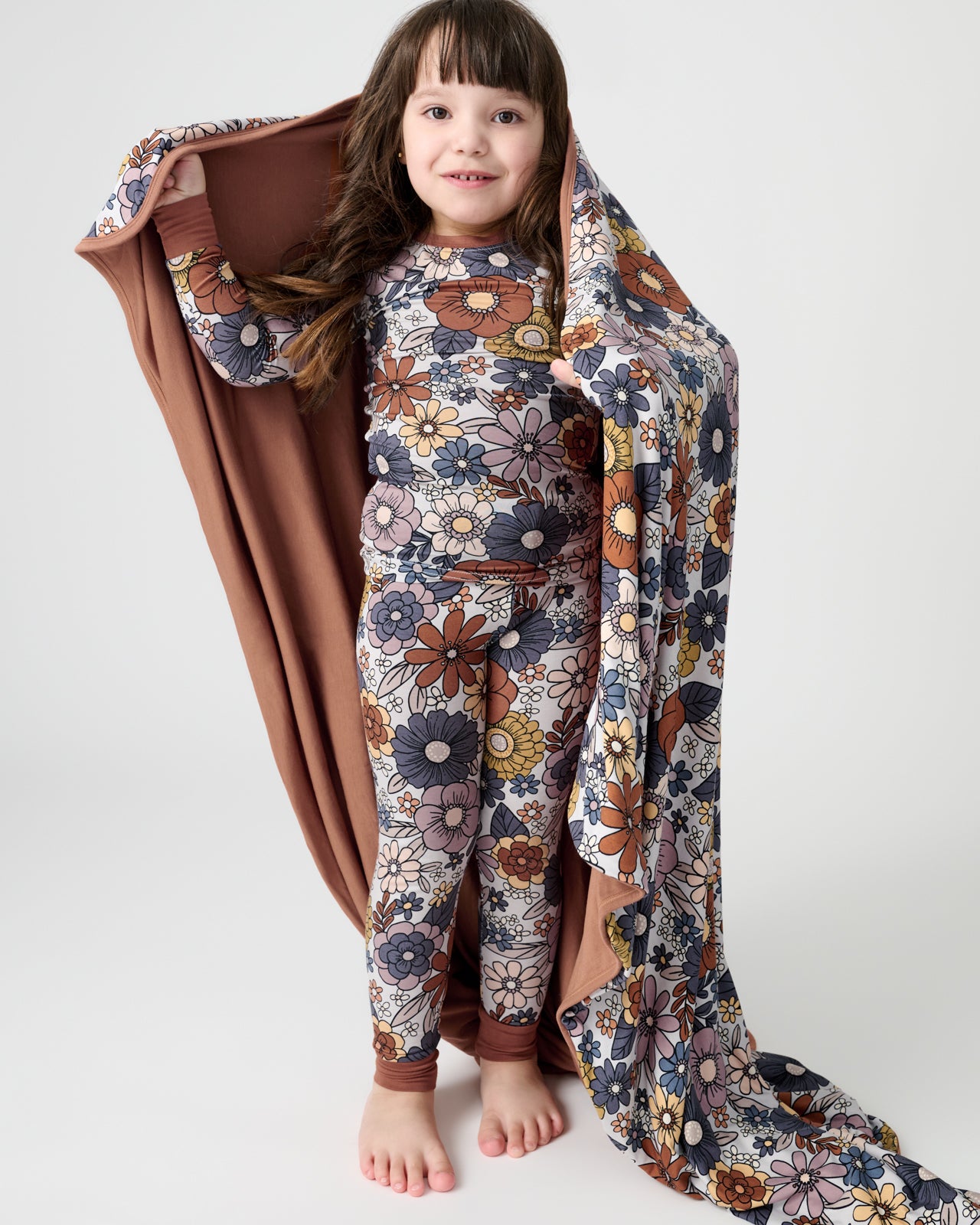 Standing girl wrapped in the Wildwood Floral Large Cloud Blanket®
