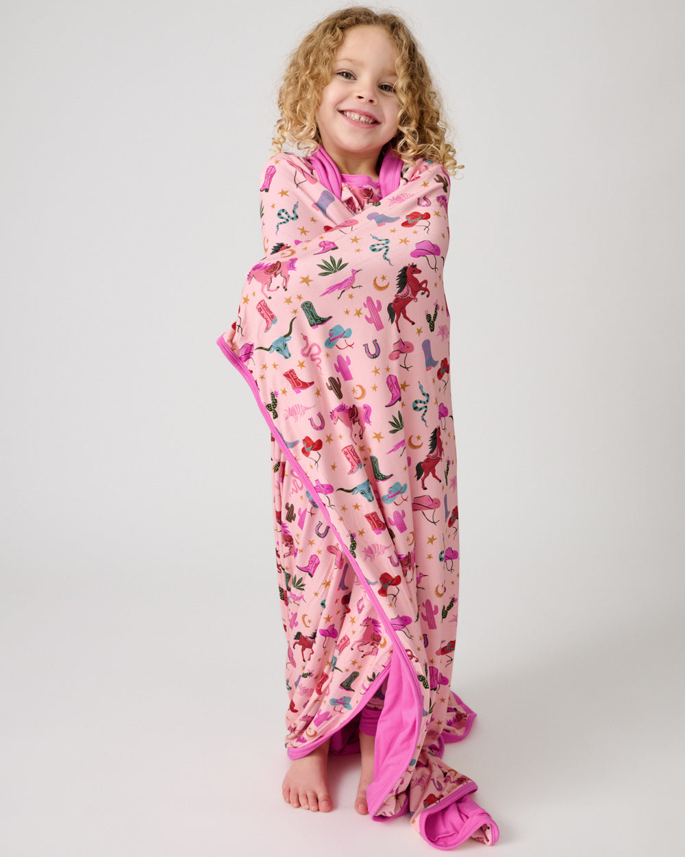 Girl wrapped in the Pink Rancher Roundup Large Cloud Blanket®