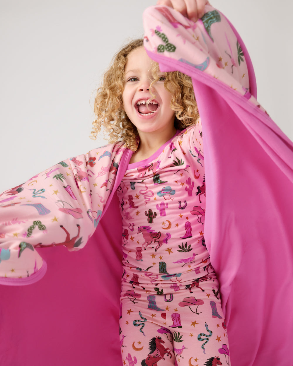 Close up of girl wrapped in the Pink Rancher Roundup Large Cloud Blanket®