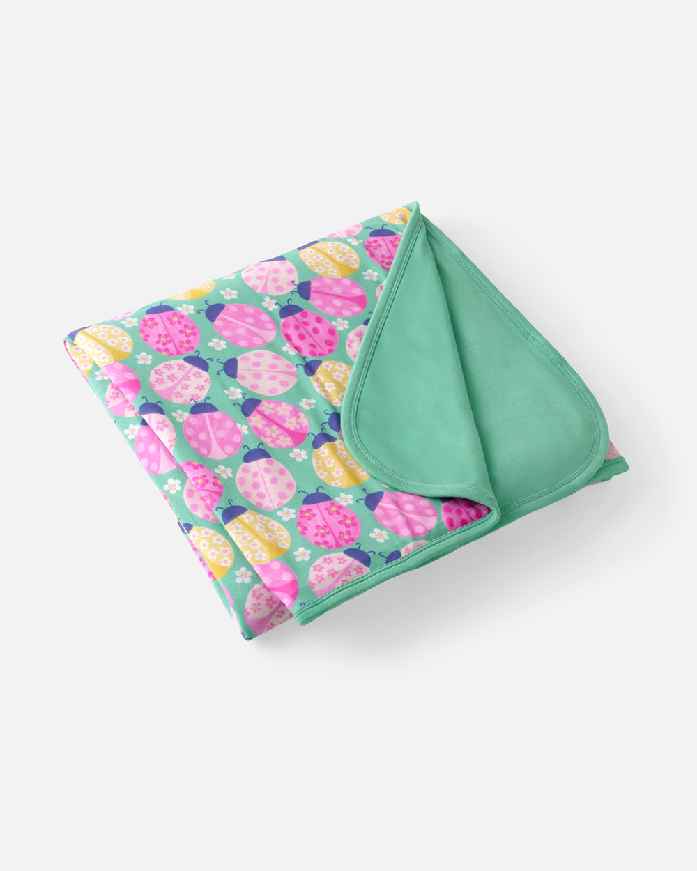 Flat lay of the Ladybug Meadow Large Cloud Blanket®