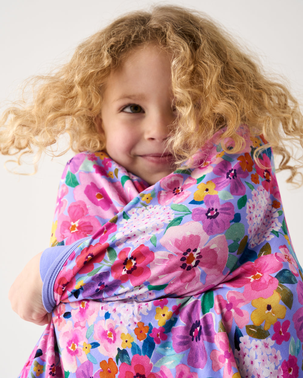Close up of girl wrapped in the Sweet Sprigs Large Cloud Blanket®