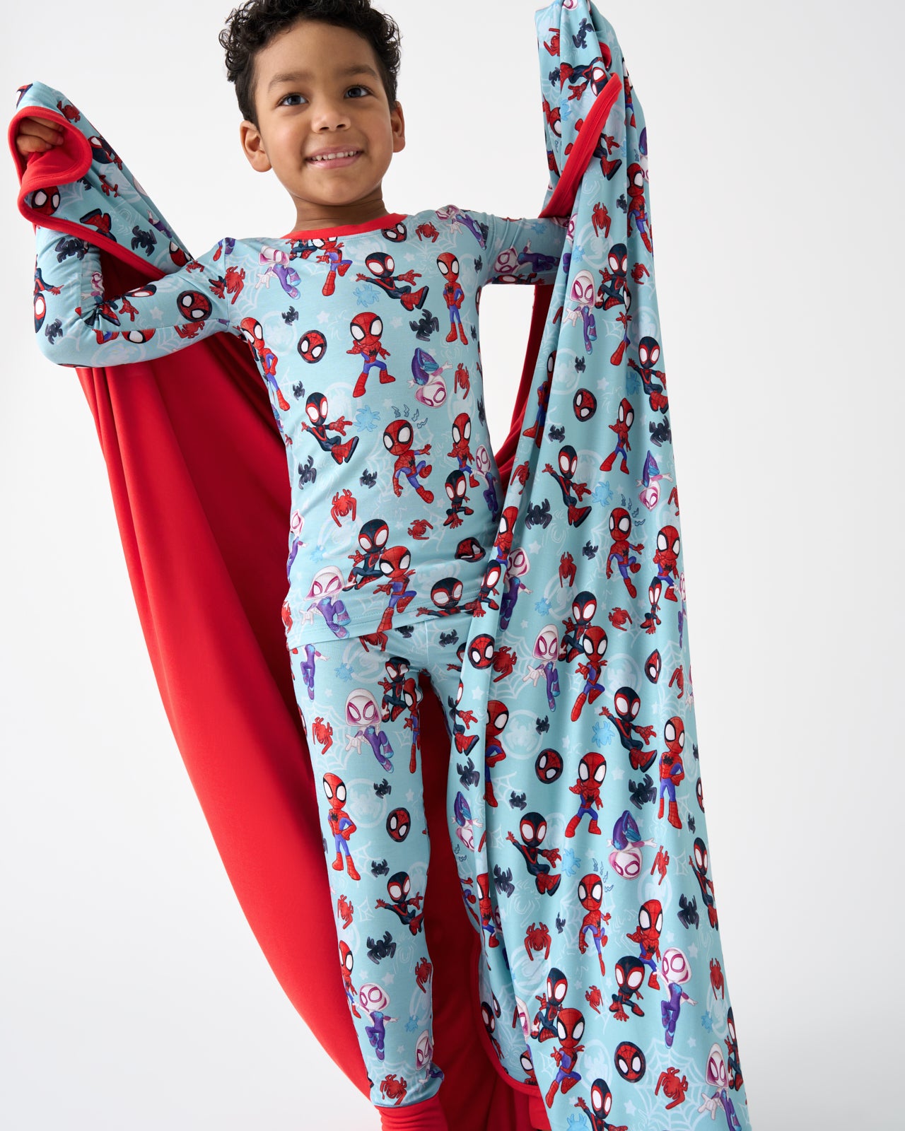 Boy holding the Spidey & Friends Tiny Webs Large Cloud Blanket®