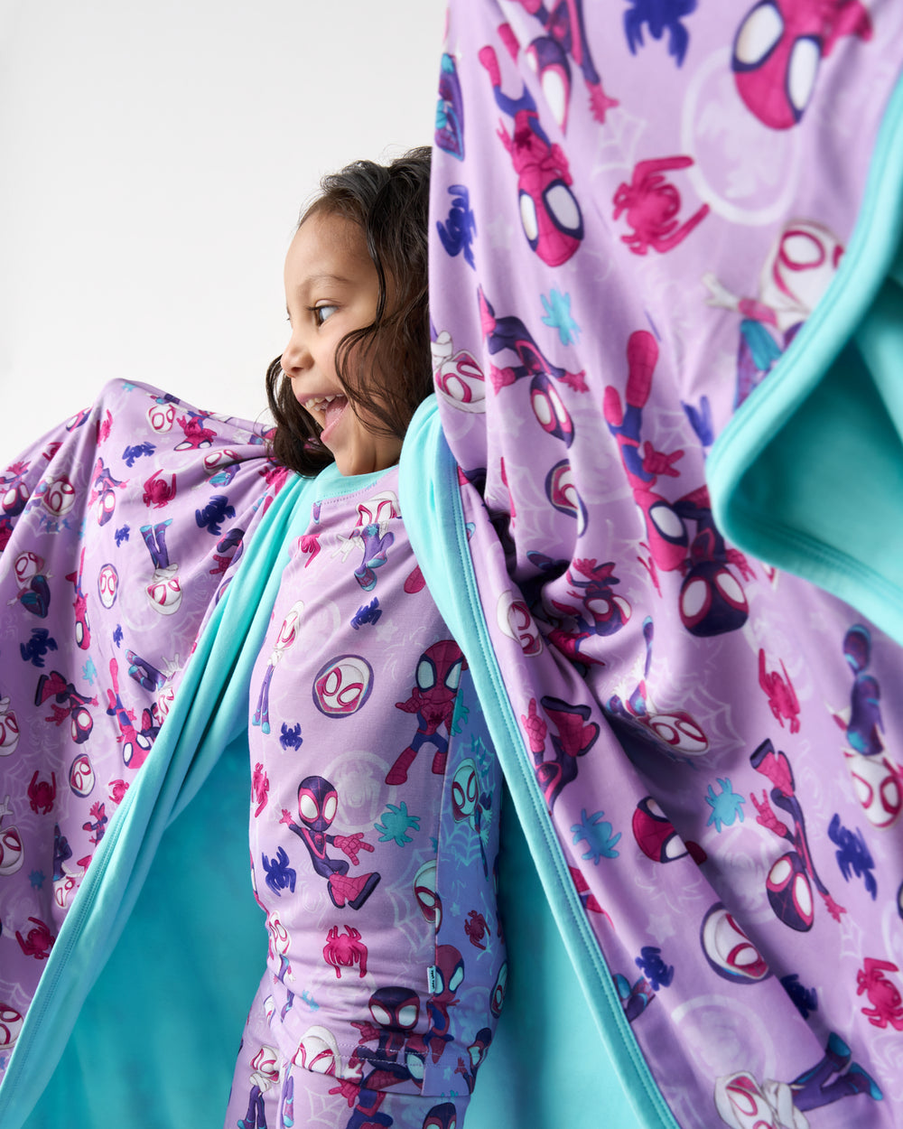 Child in motion holding the Purple Spidey & Friends Tiny Webs Large Cloud Blanket®