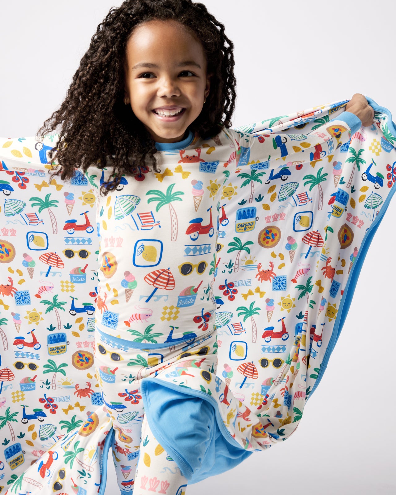 Girl holding out the Ciao Bella Large Cloud Blanket®