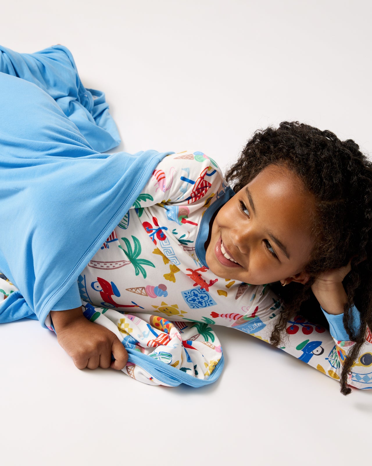 Girl wrapped in the Ciao Bella Large Cloud Blanket®