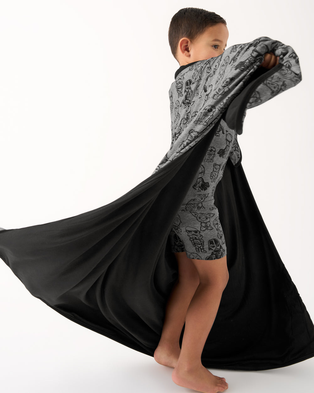 Spinning child wearing the Star Wars Far, Far, Away Friends Large Cloud Blanket®