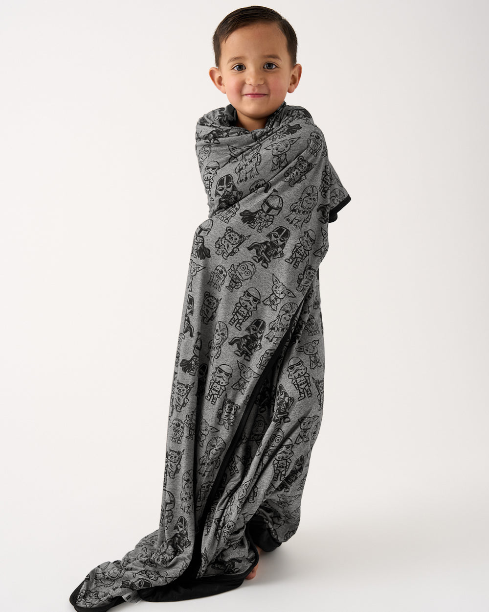 Standing boy wrapped in the Star Wars Far, Far, Away Friends Large Cloud Blanket®