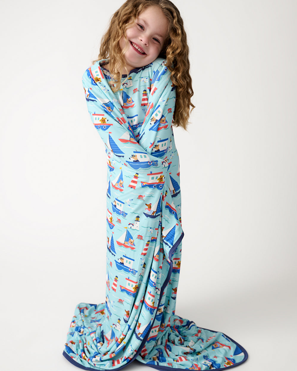 Standing girl wrapped in the Nautical Paws Large Cloud Blanket®