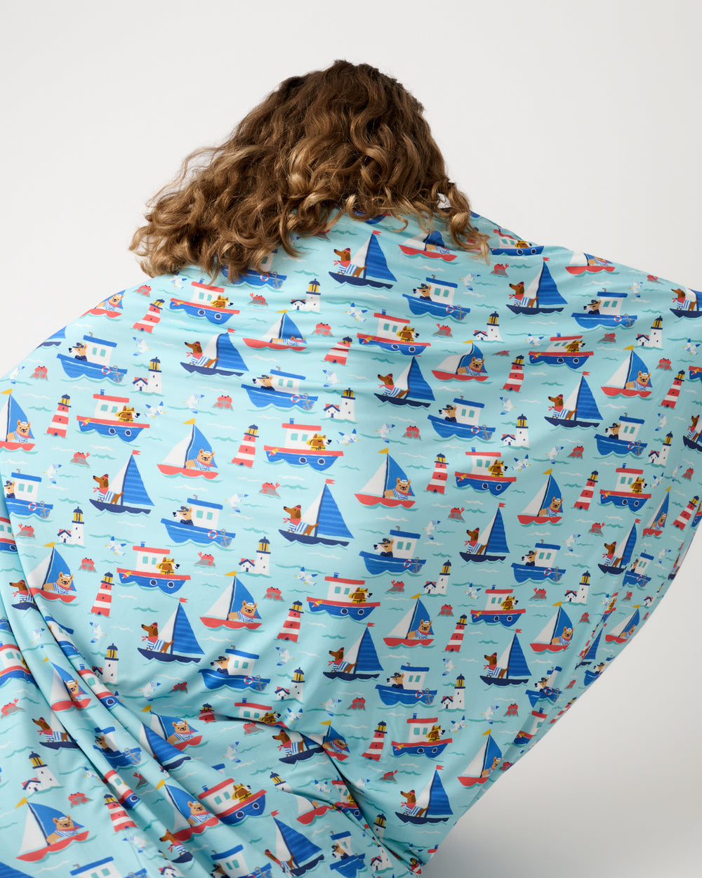 Back view of girl holding up the Nautical Paws Large Cloud Blanket®