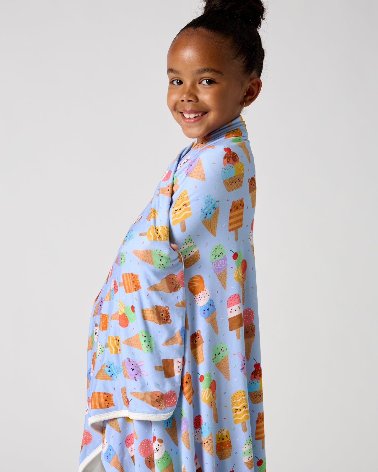 Girl wrapped in the Scoop Squad Large Cloud Blanket®