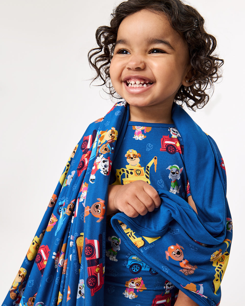 Close up of child wrapped in the PAW Patrol Adventure Bay Heroes Large Cloud Blanket®