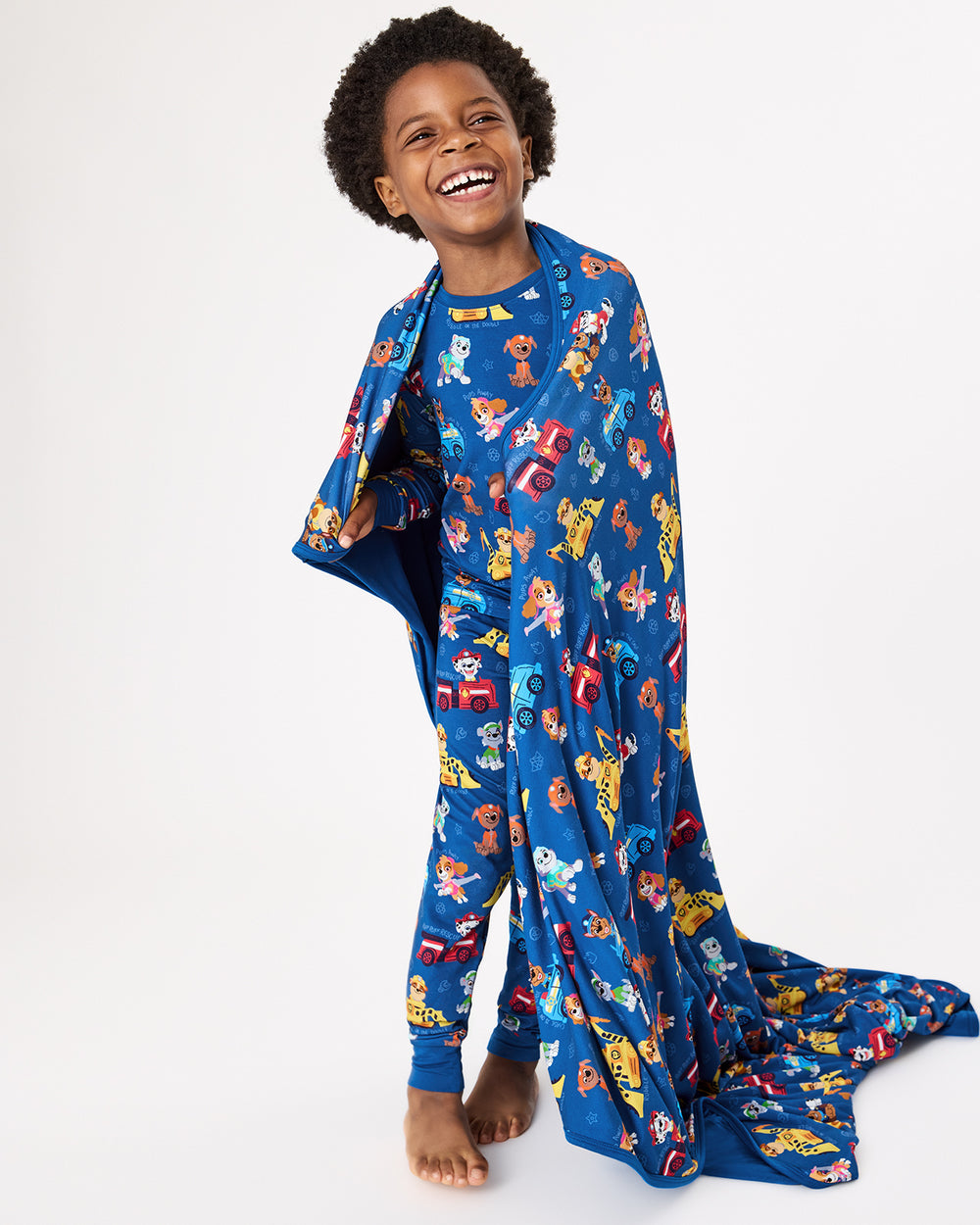 Child with the PAW Patrol Adventure Bay Heroes Large Cloud Blanket® over his shoulders