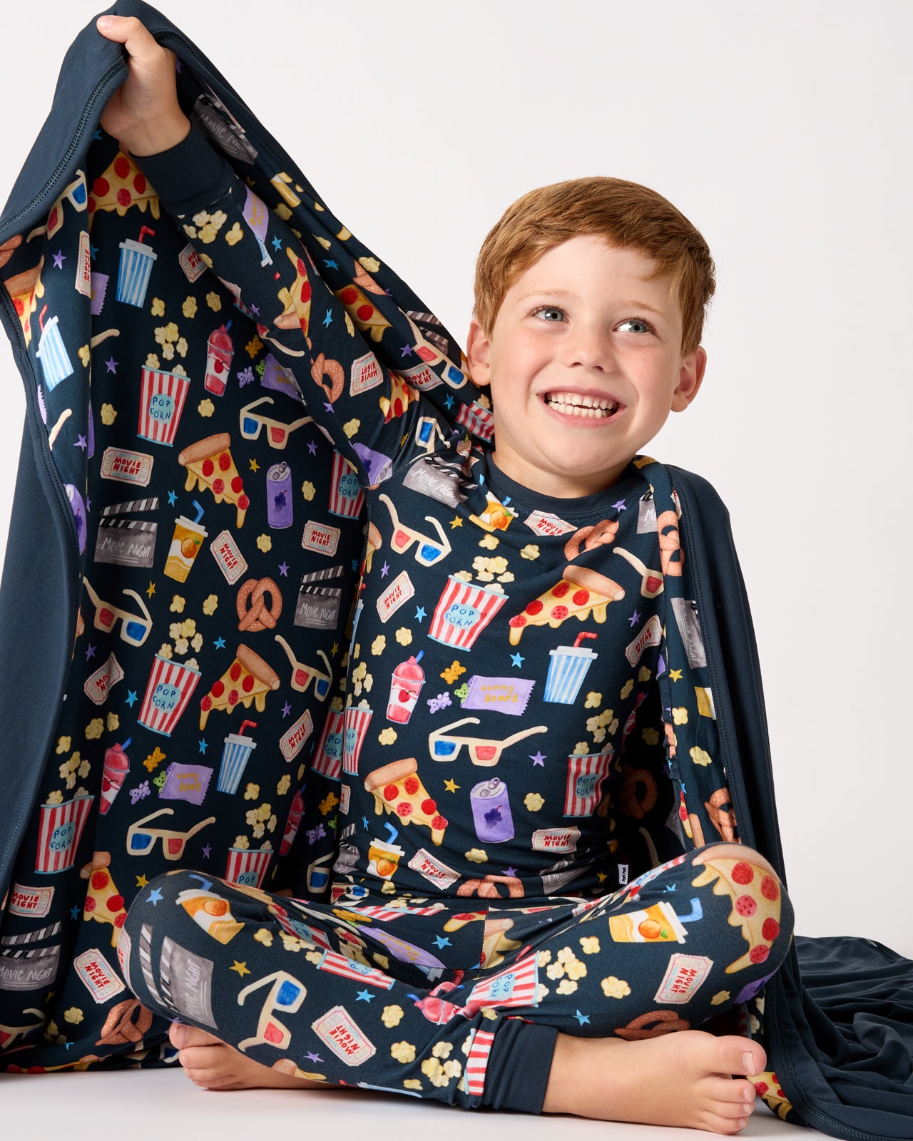 Boy holding up the Movie Marathon Large Cloud Blanket®