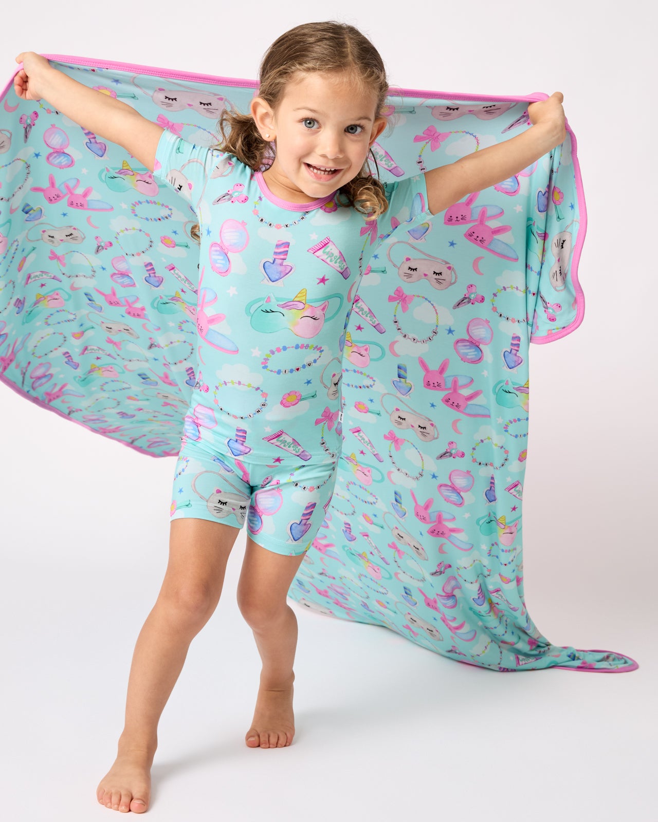Girl holding up the Slumber Club Large Cloud Blanket®