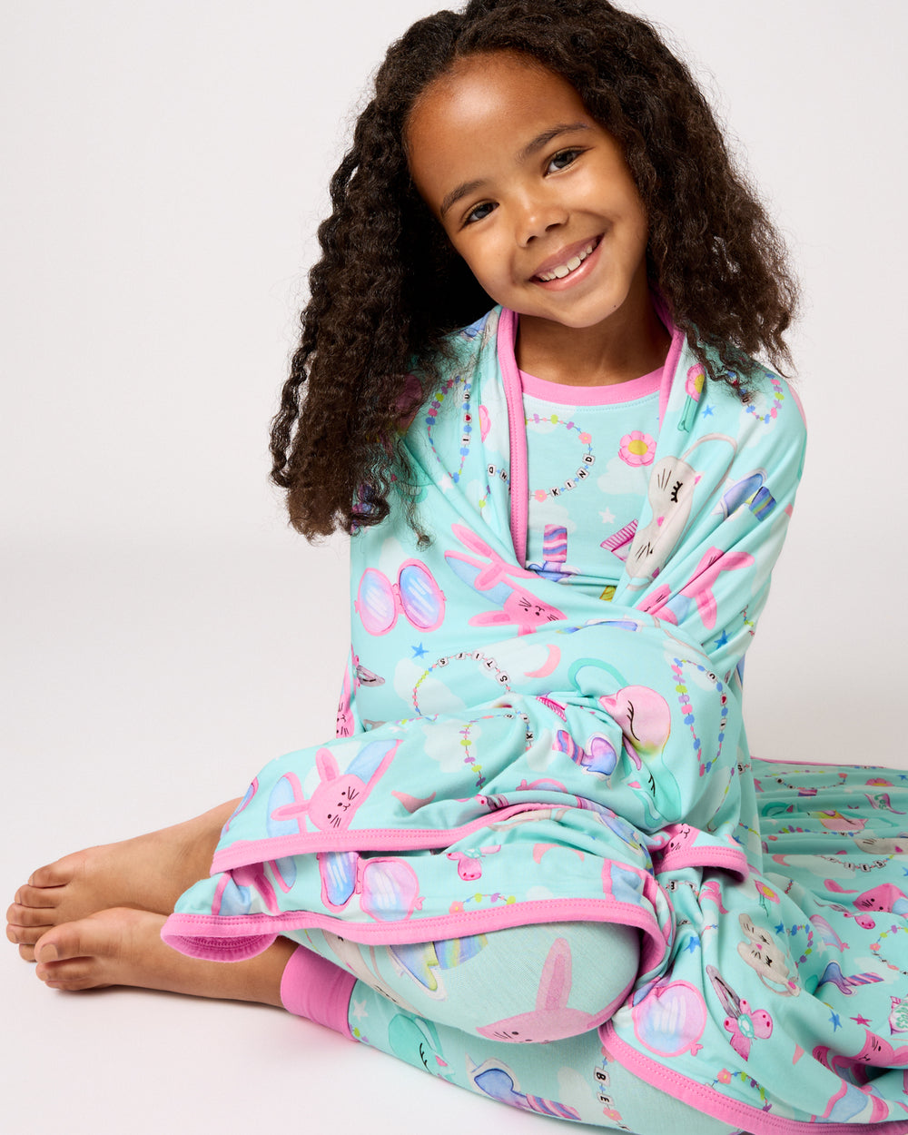 Girl with the Slumber Club Large Cloud Blanket® wrapped over her shoulders