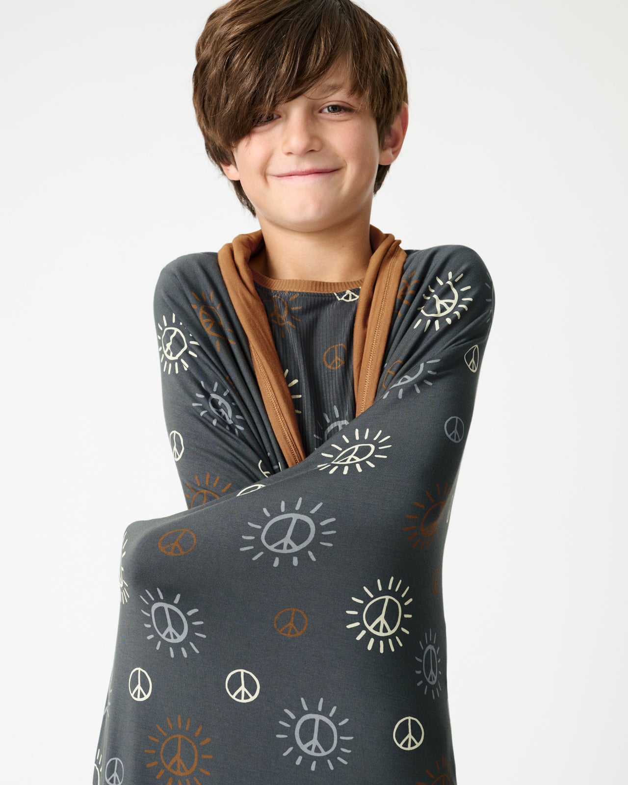 Boy wrapped in the Peace & Love Large Cloud Blanket®