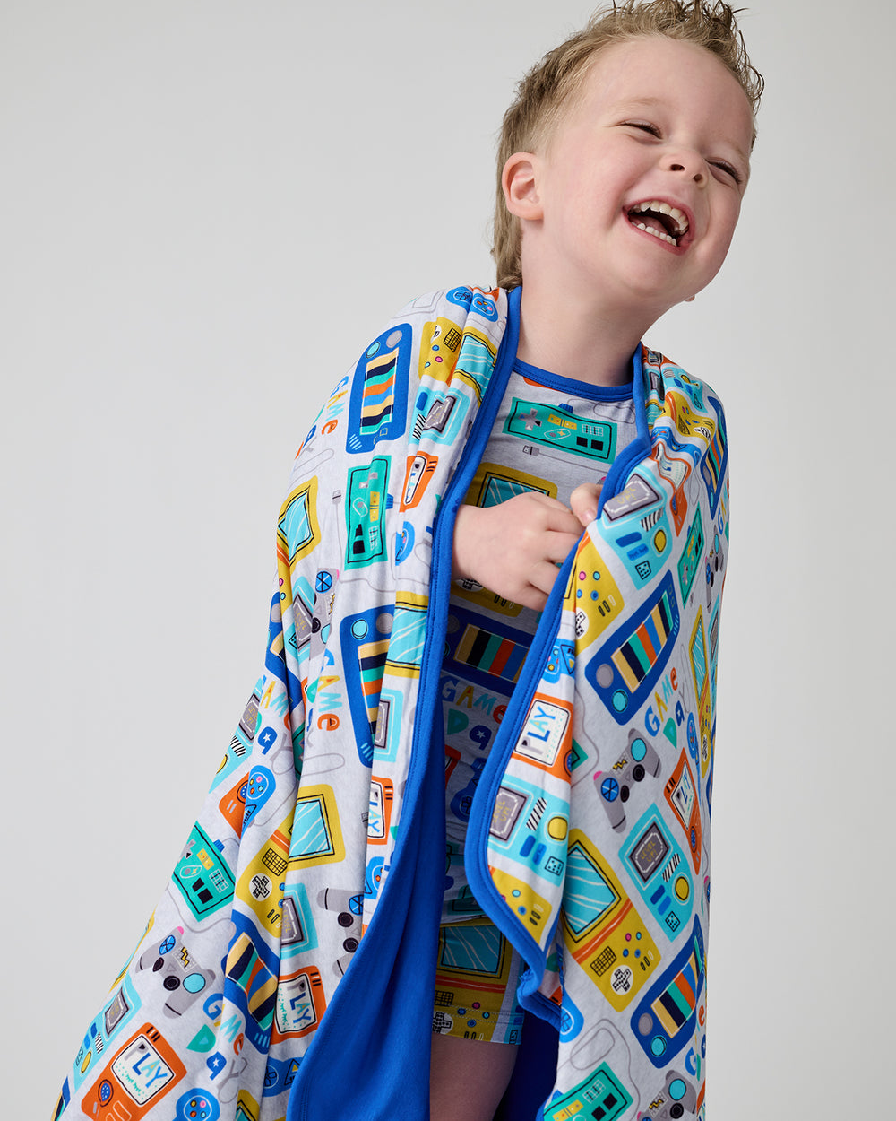 Laughing boy wrapped in the Game On Large Cloud Blanket®