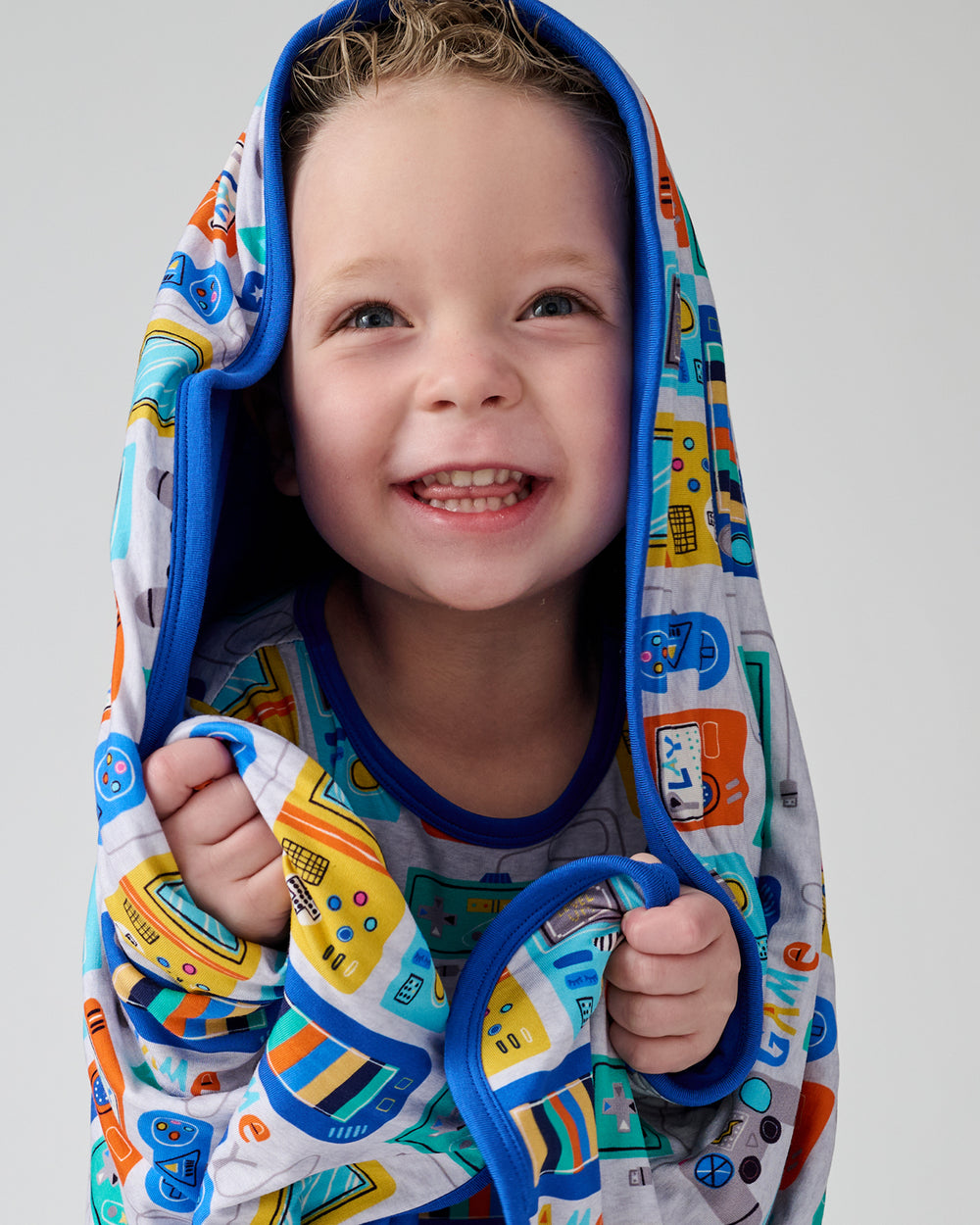 Close up of boy with the Game On Large Cloud Blanket® draped over his head