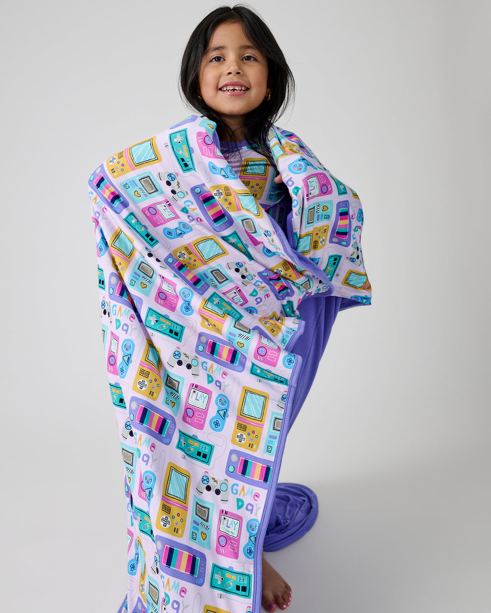 Standing girl wrapped in the Purple Game On Large Cloud Blanket®