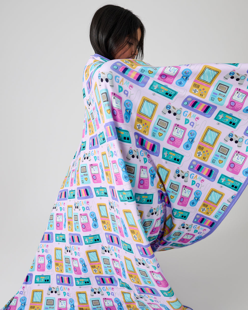 Child in motion wrapped in the Purple Game On Large Cloud Blanket®