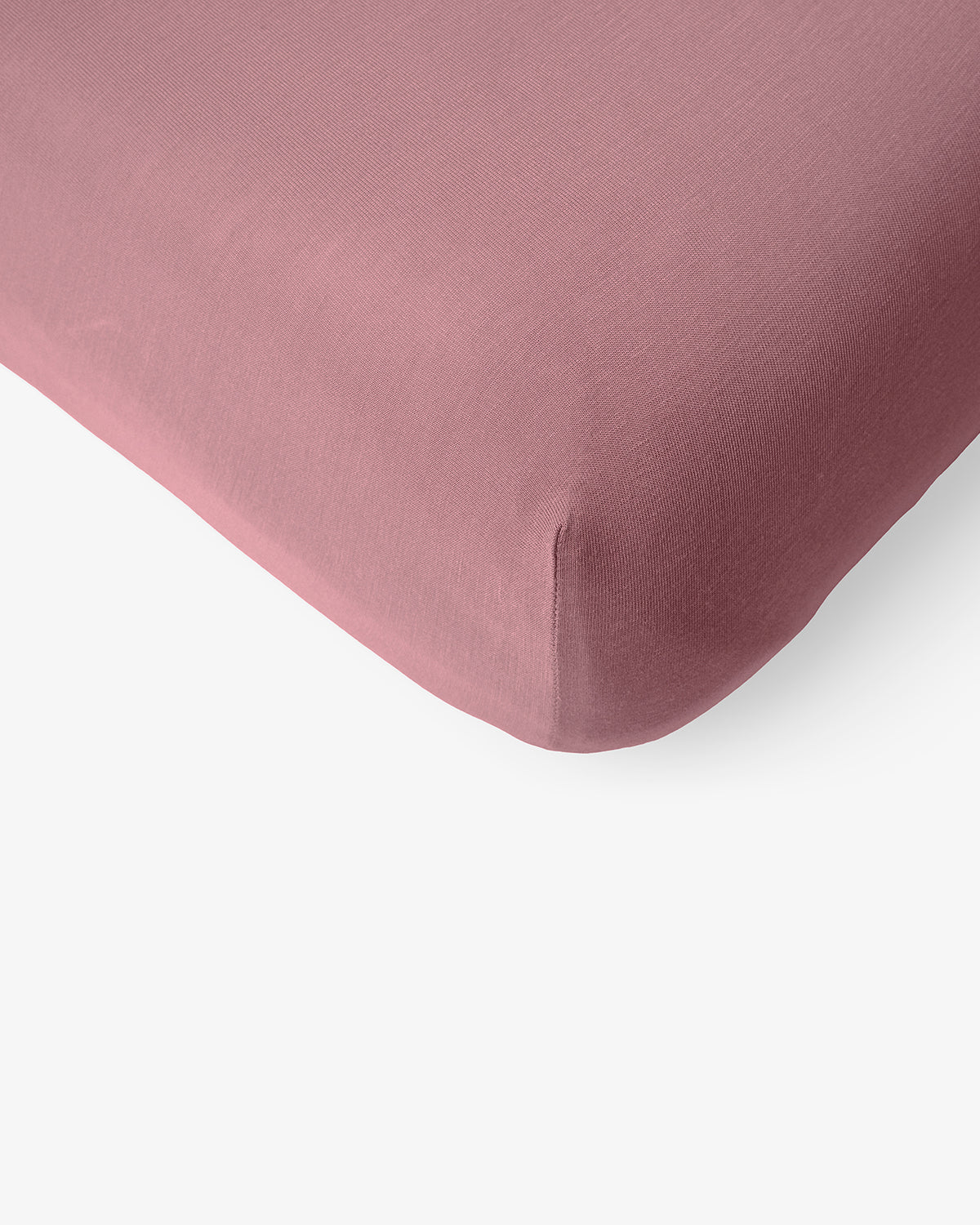 Macro view of the corner of the Rosewood Mini Crib Sheet