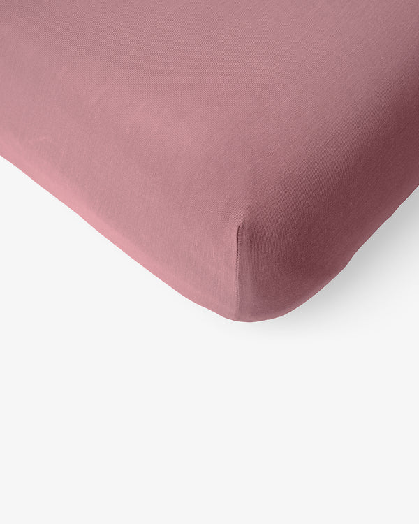 Macro view of the corner of the Rosewood Mini Crib Sheet