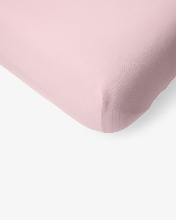 Macro view of the corner of the Prima Pink Fitted Mini Crib Sheet
