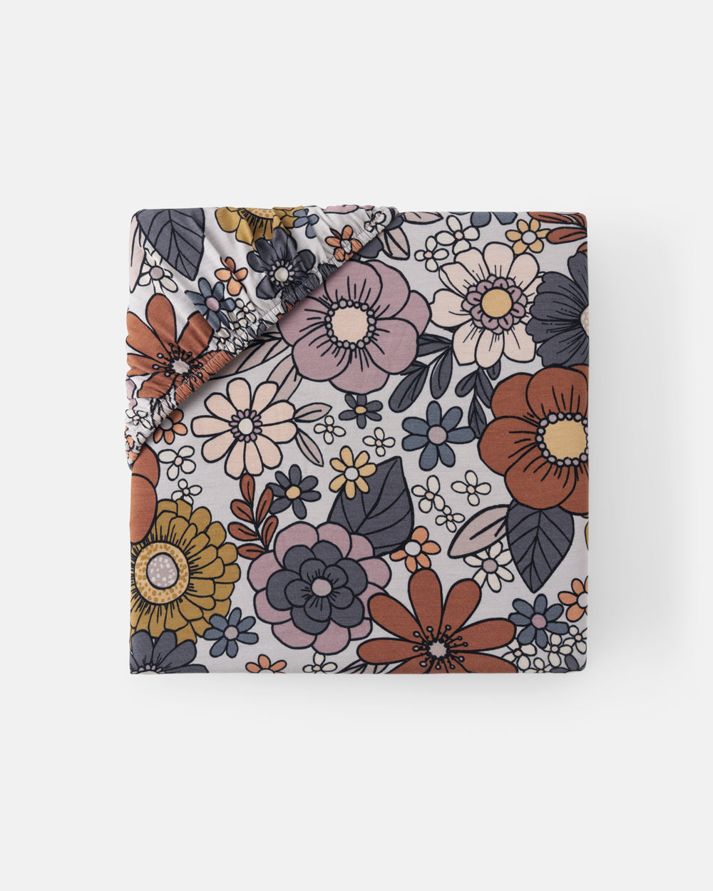 Flat lay of the Wildwood Floral Mini Fitted Crib Sheet