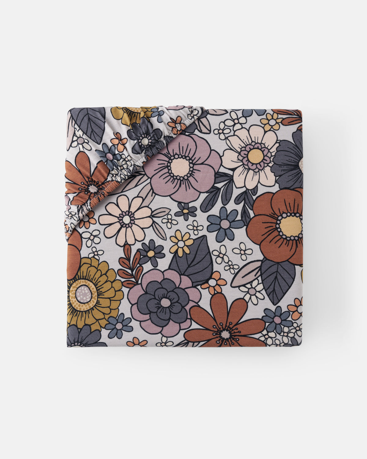 Flat lay of the Wildwood Floral Mini Fitted Crib Sheet