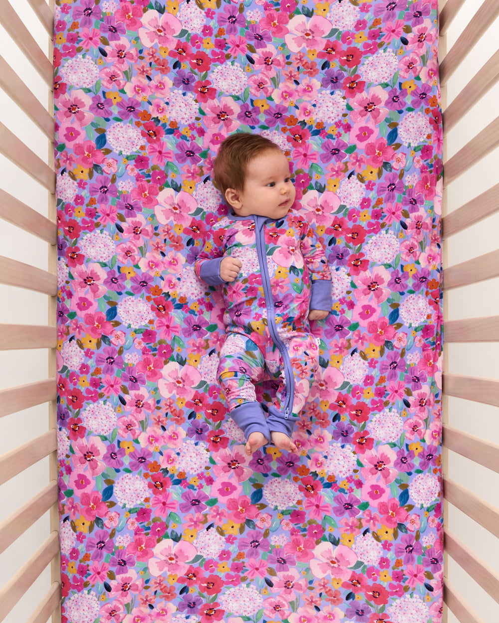 Overhead view of baby laying on the Sweet Sprigs Fitted Crib Sheet