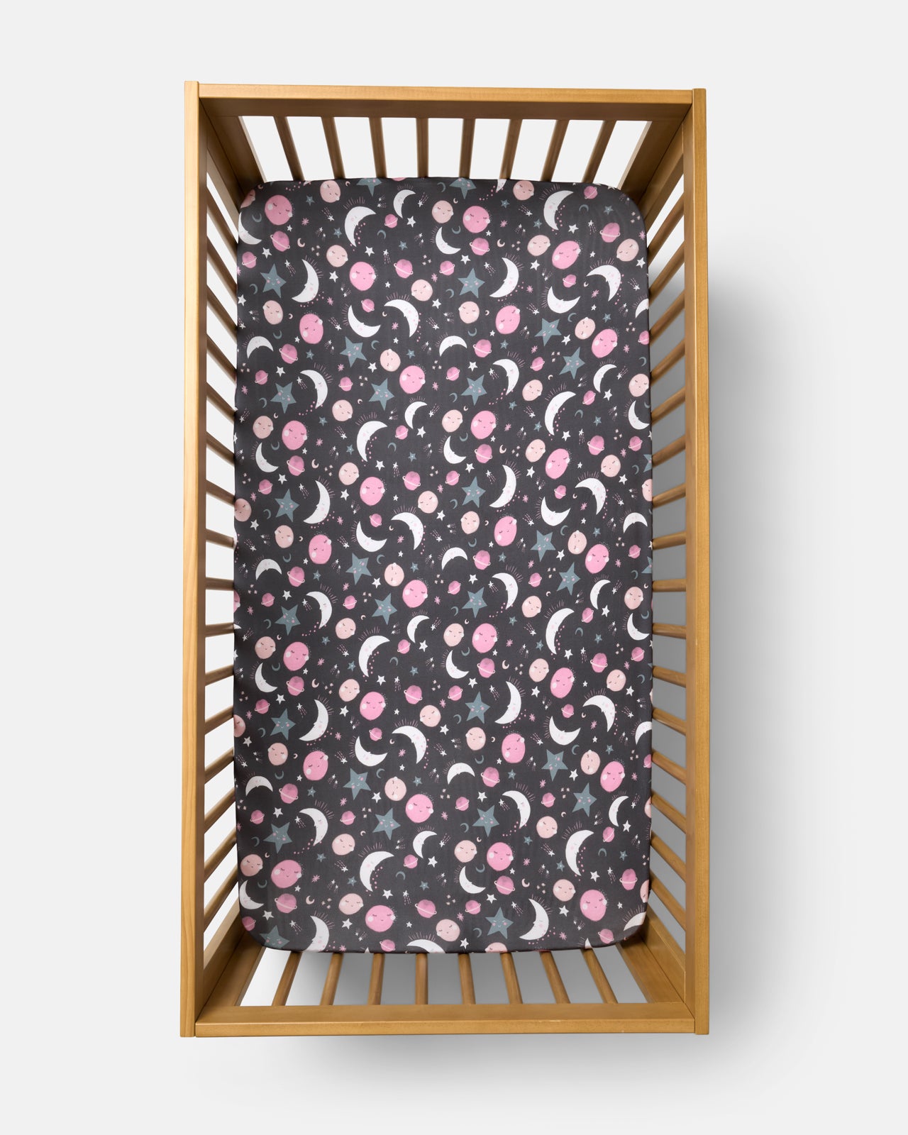 Flat lay of the Pink To the Moon & Back Fitted Crib Sheet